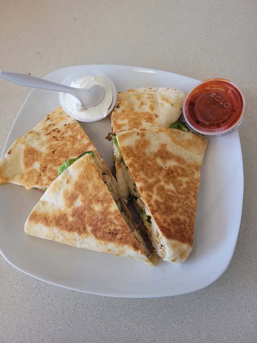 Chicken quesadilla with sour cream and salsa
