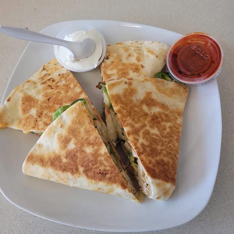 Chicken quesadilla with sour cream and salsa