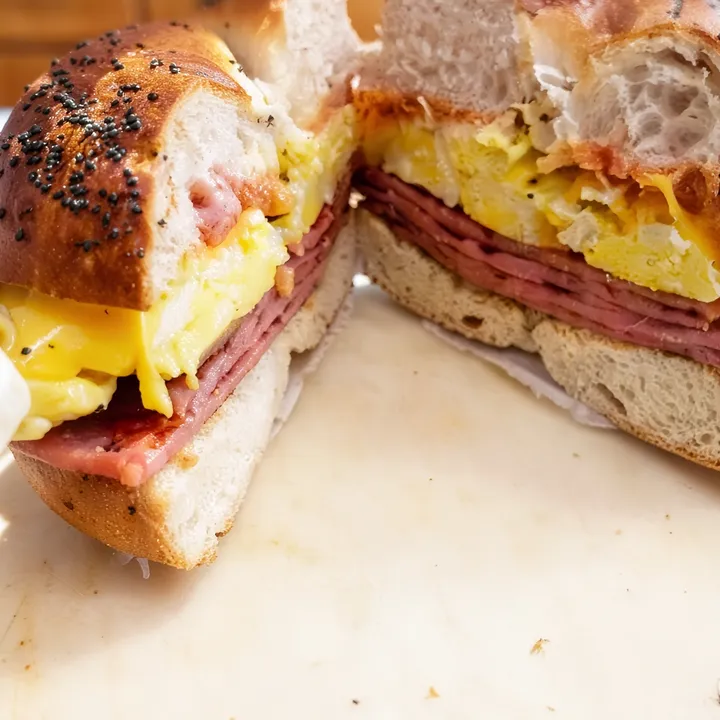 Pork roll, egg and cheese on a bagel, cut in half