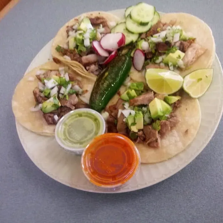Tacos with radish, cucumber, a grilled jalapeño and two salsas